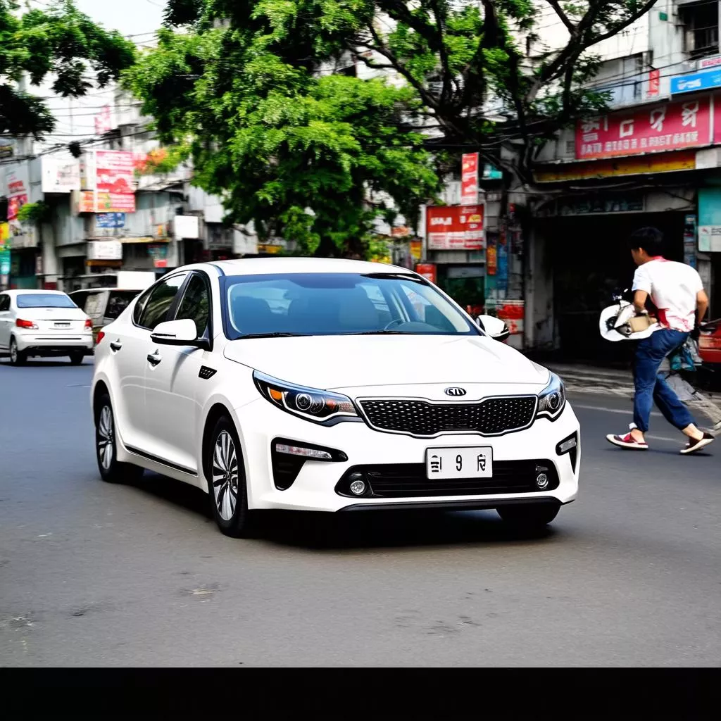 White Kia Optima driving on Hanoi street