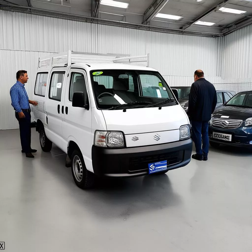 A man inspecting a used Suzuki Van truck