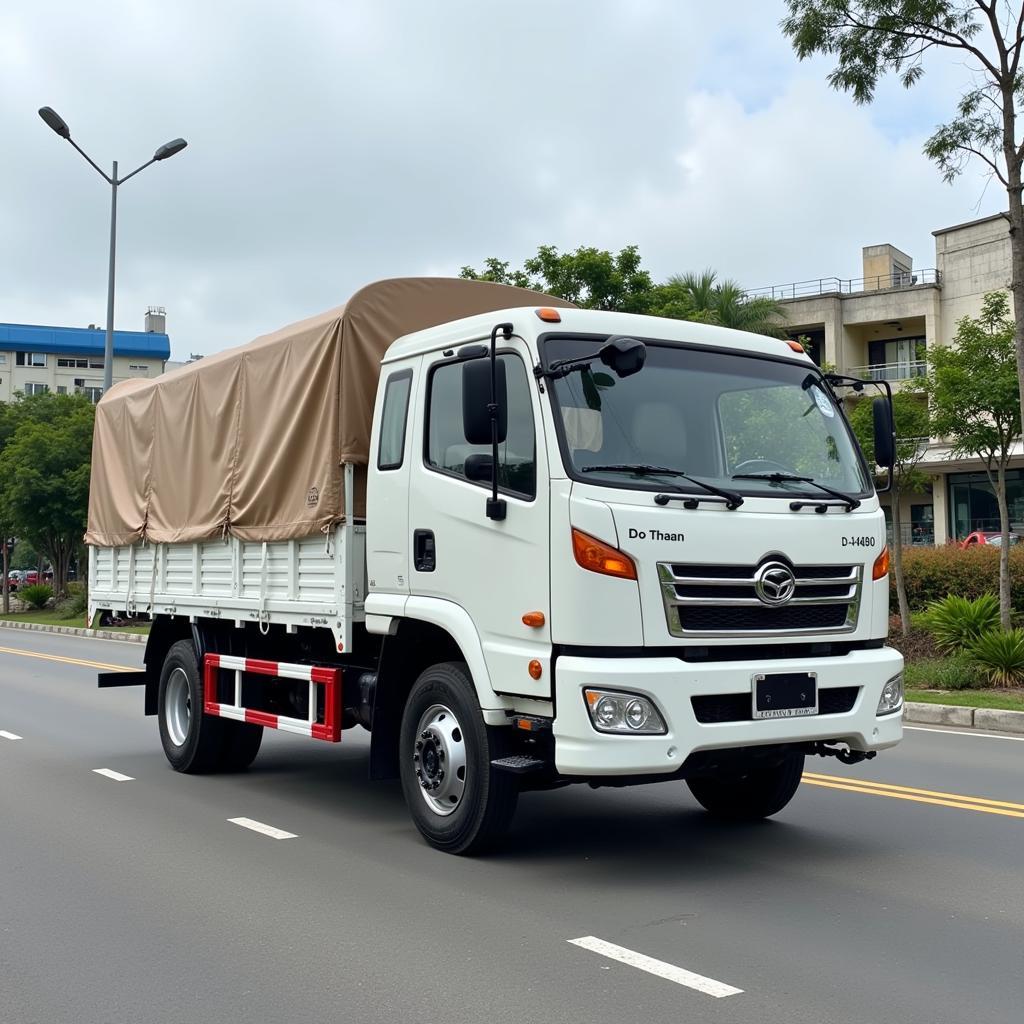 A white 2-ton Do Thanh truck with a canvas cover transporting goods on the road